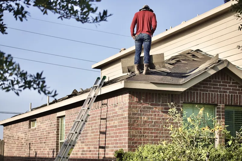 Professional roofer working on a residential roof in Veterans Park